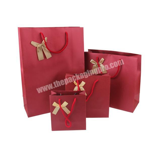 Factory price Hot selling beauty red  bowknot matteglossy gift paper bag with string