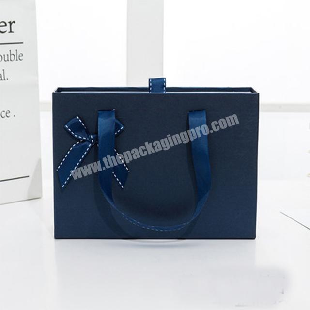 luxury blue drawer inner box with paper bag flower decoration in front for gifts boxes bags