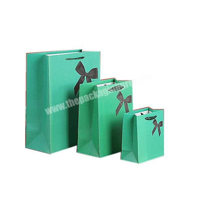 Free Creative brand namelogo green matteglossy gold foil  gift paper bag for packaging