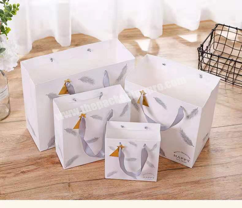 Wholesale custom logo portable gift packaging paper bag for shopping