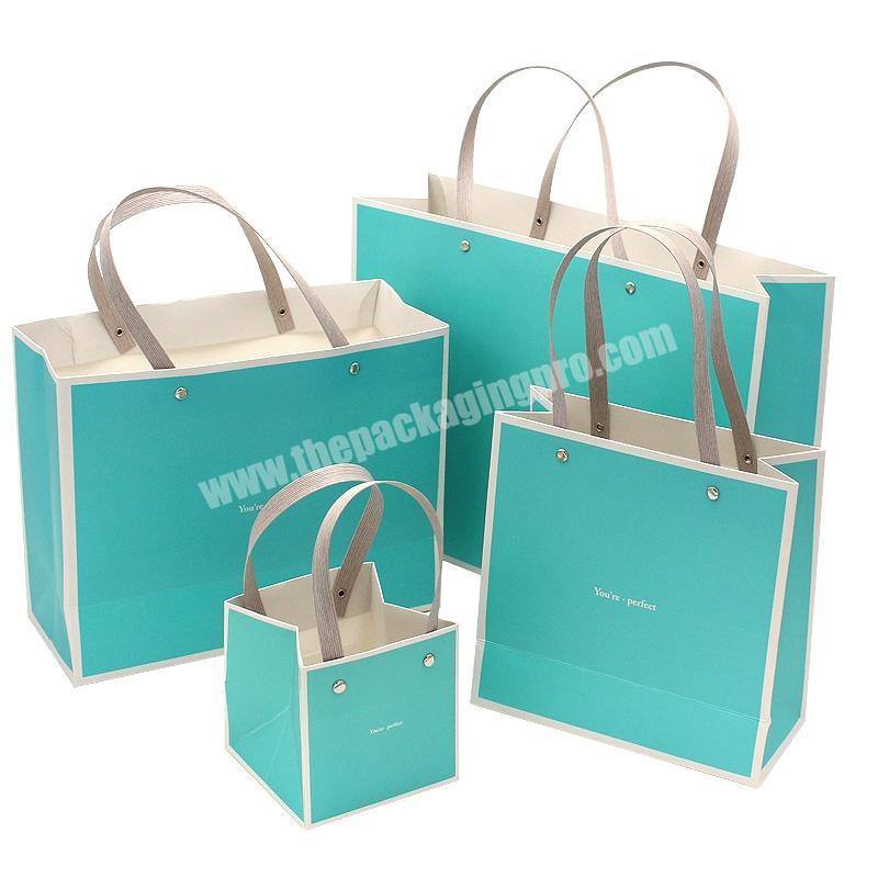 Cheap small sugar gift paper packaging bags with ribbon handles