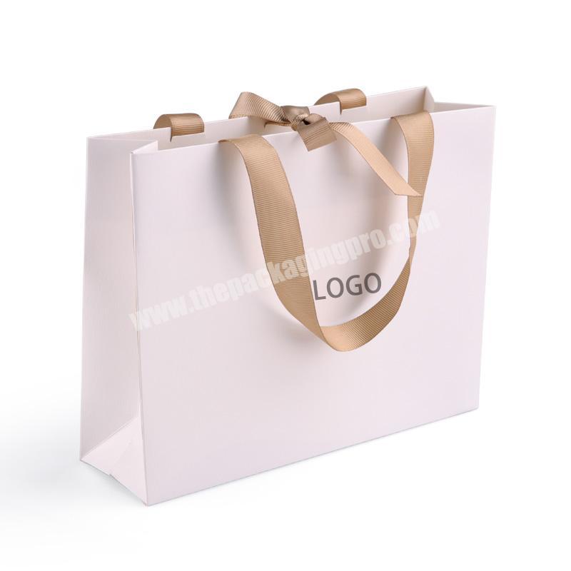 Hot sales customized logo luxury fancy paper clothes shopping bag with ribbon wholesales