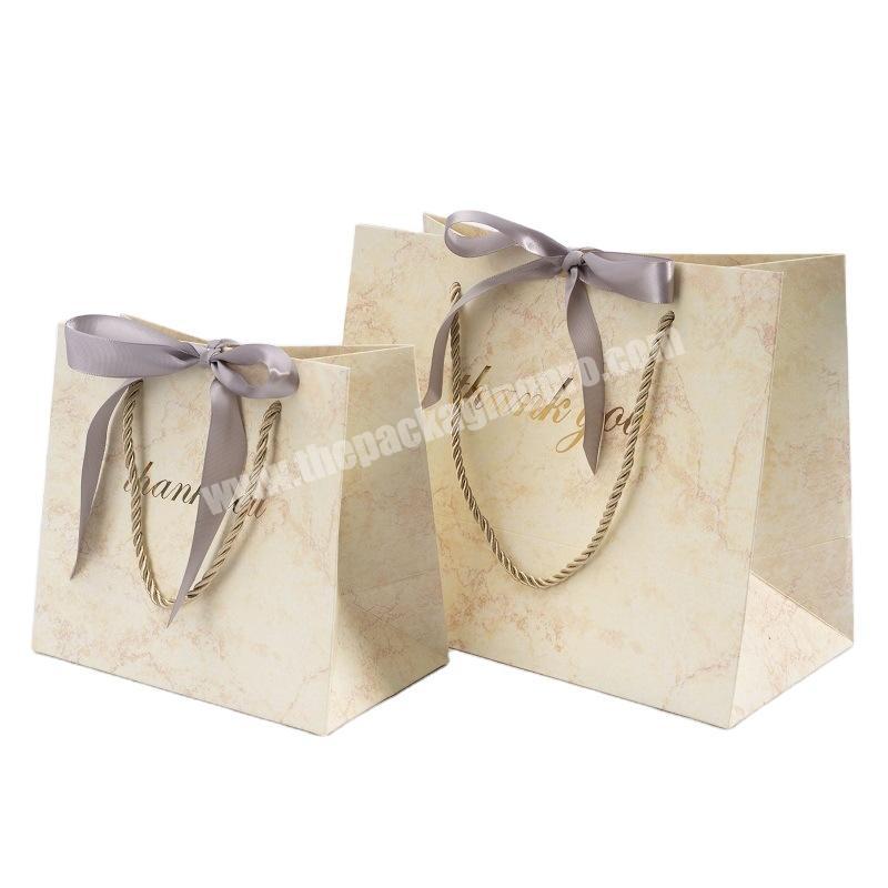 Hot selling cardboard luxury paper shopping clothes packing paper gift bag with customized logo