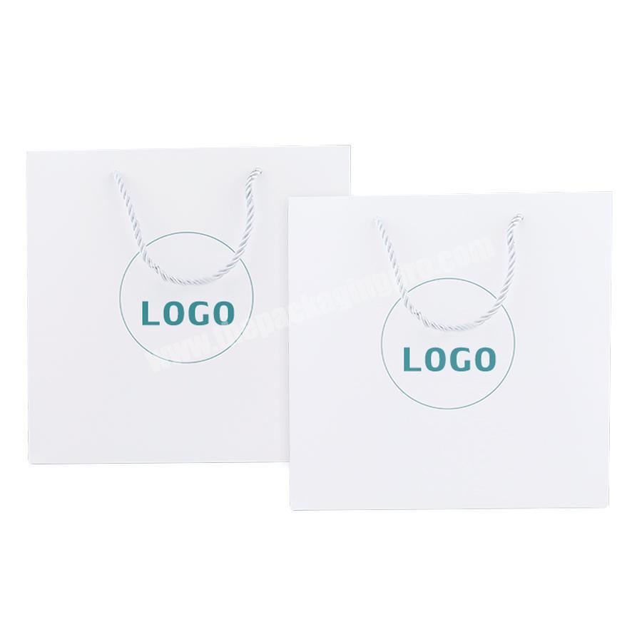 Packaging bag for clothe custom logo gold foil printed white cloth paper packaging bag with handle