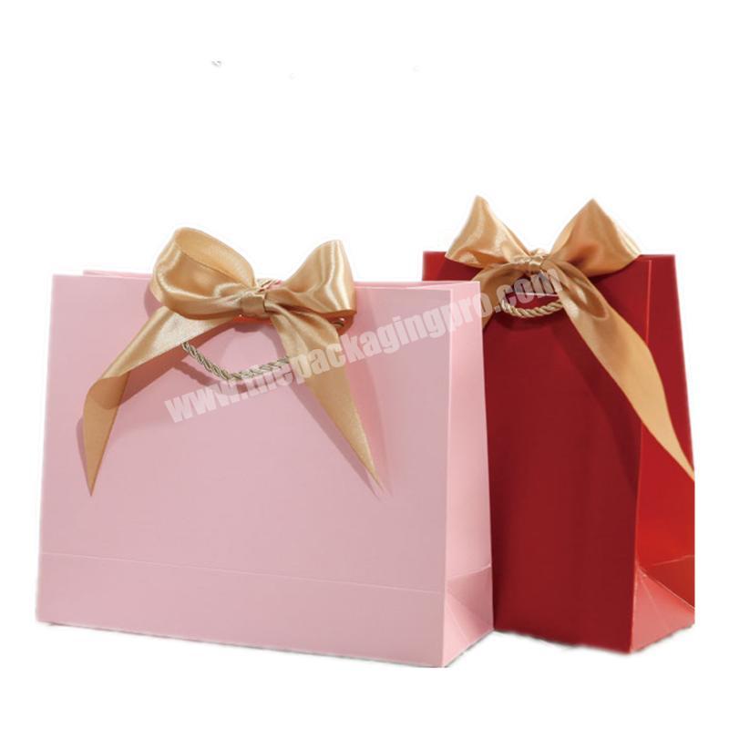 Factory wholesale cheap small paper bag customized color print stripe gift paper bag manufacturer with ribbon