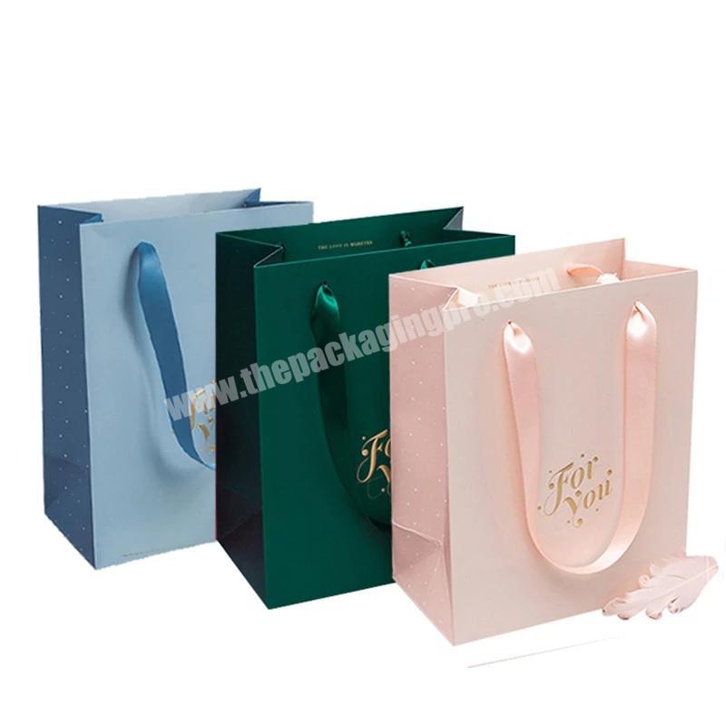 China wholesale logo paper bagging clothes bags paper custom logo paper bag with ribbon handle