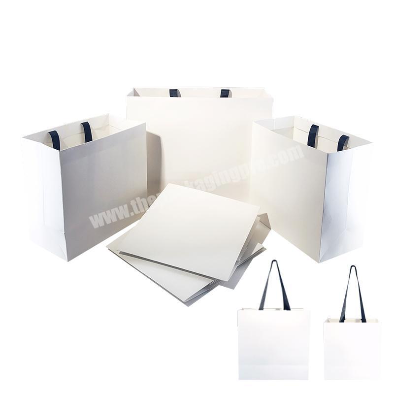Recyclable custom logo white big paper bag embossing paper bag with ribbon handle