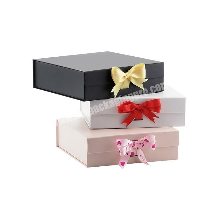 Low MOQ medium pink folding magnetic snap shut lid gift box with ribbon for clothing