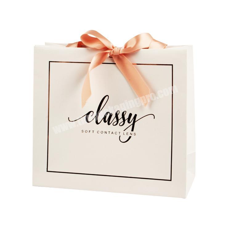 Luxury embossing rose gold logo gift paper bag with ribbon row