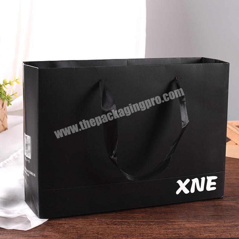 China Factory upscale clothing stores packaging paper carrier bag black printed ivory board packing paper bag