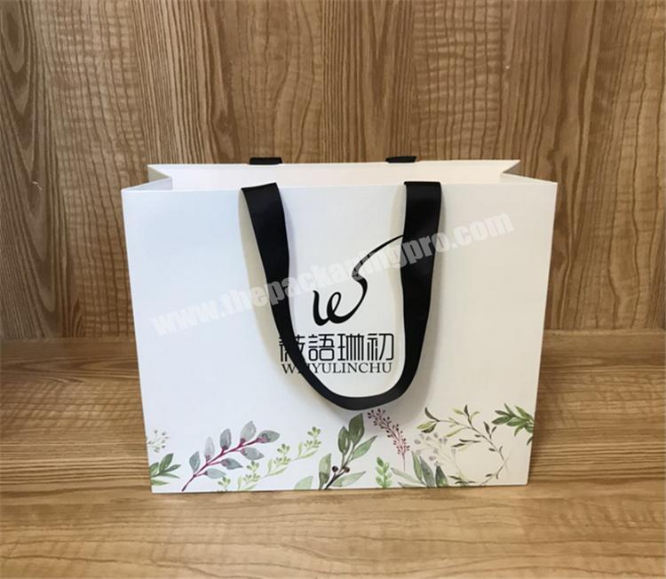 custom black luxury matt laminated paper bag with ribbon flower packaging