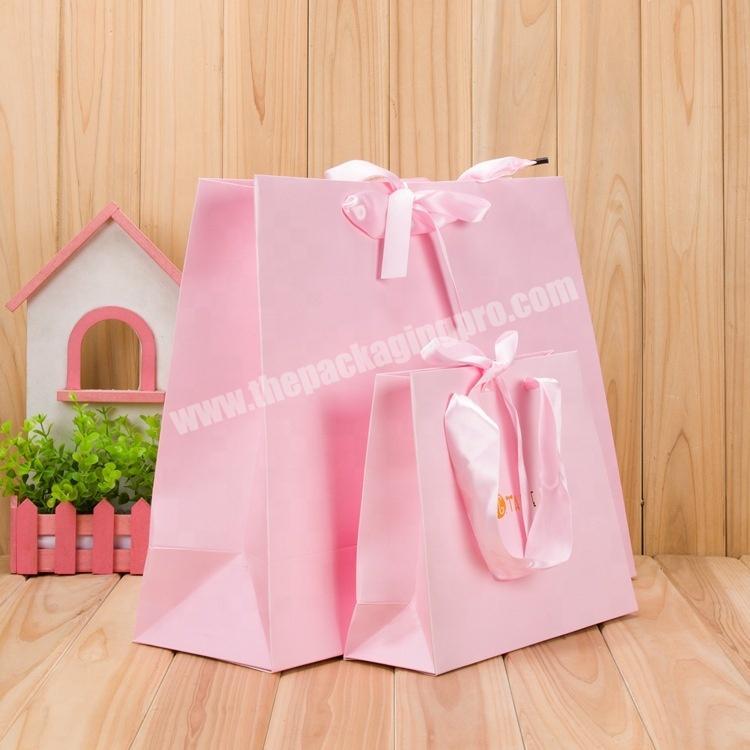 Custom pink apparel luxury retail paper shopping bag with logo