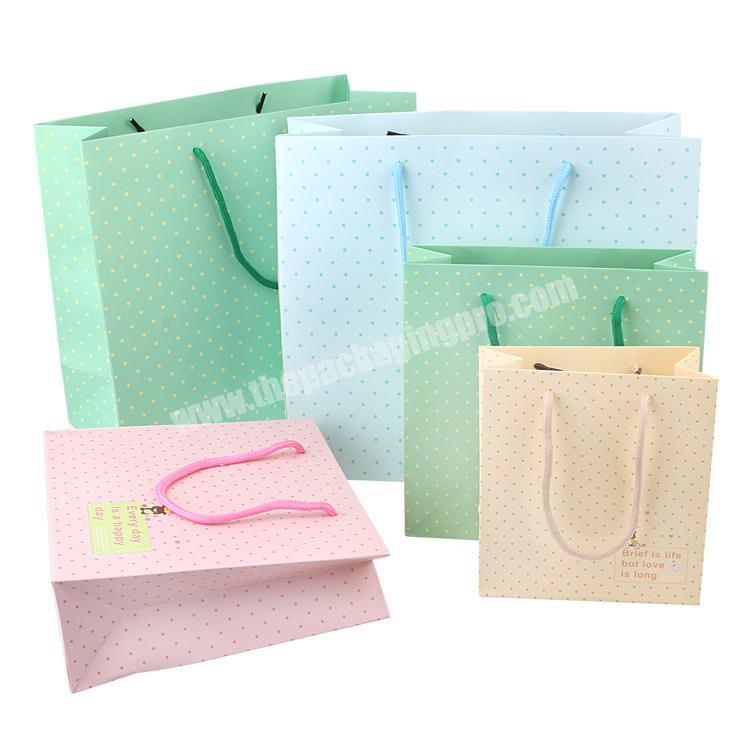 Custom small quantity luxury merchandise paper bags for clothing packaging