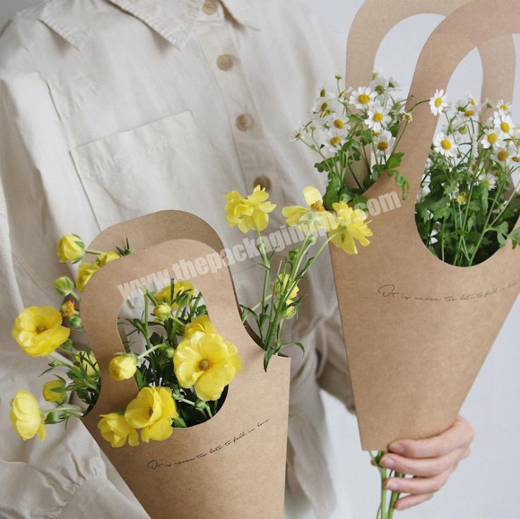 Peony flowers bouquet in kraft paper bag flat lay (1436366)