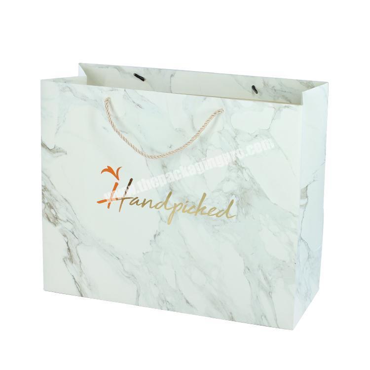 Large gold stamp logo custom cosmetic makeup marble paper bag rope handle for wholesale