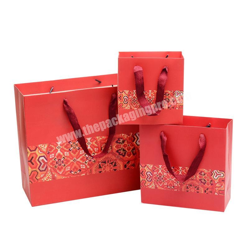 Luxury matte red shopping paper bag with logo for clothing packaging