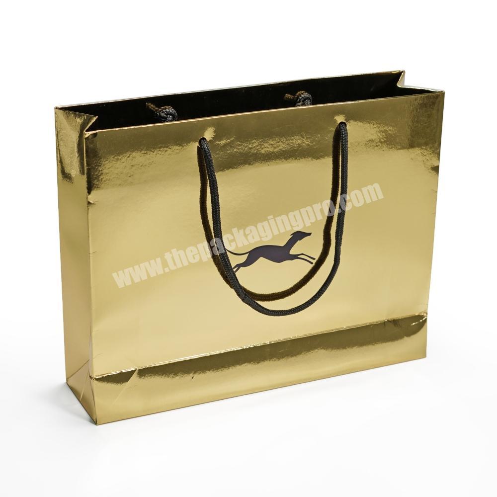luxury shiny gold paper shopper bag with black foil and emboss logo