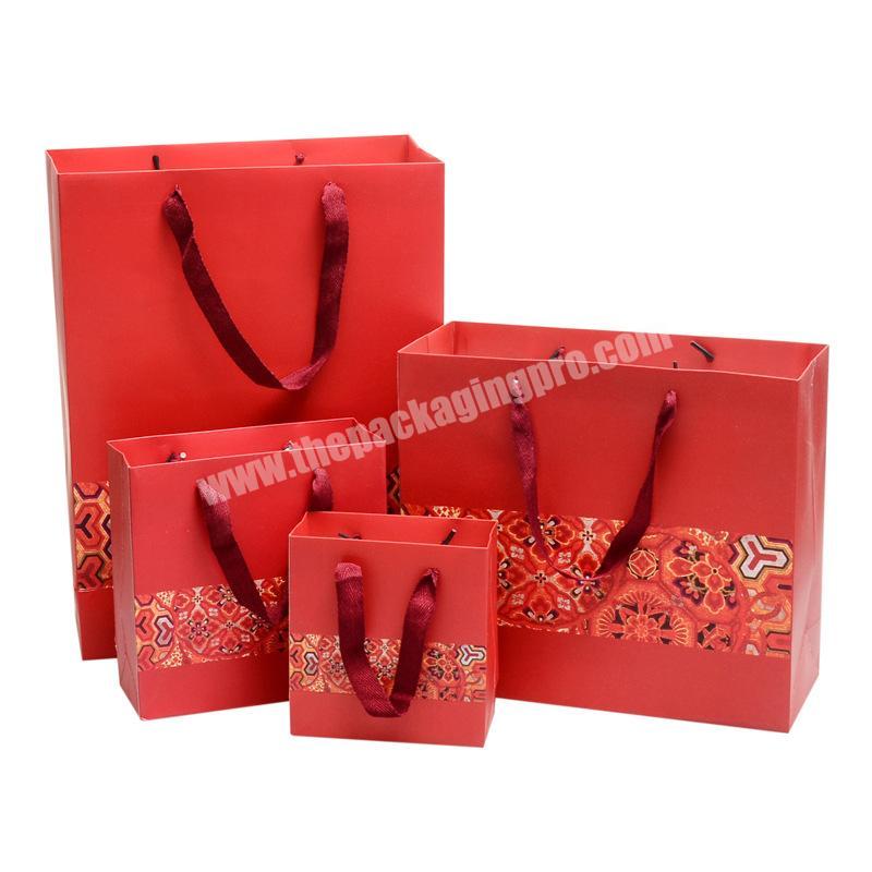 Manufacturer customized design recyclable gift packing paper bag with fabric handle