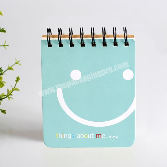 Personalized cheap paper spiral notebook exercise books with smile logo