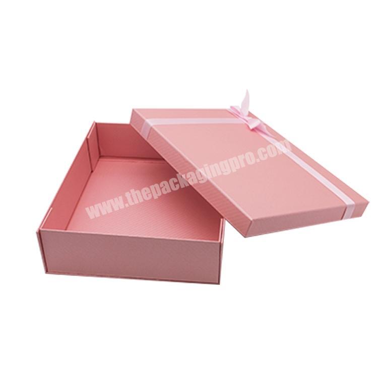 Pink foldable paper box with ribbon for clothing and shoes