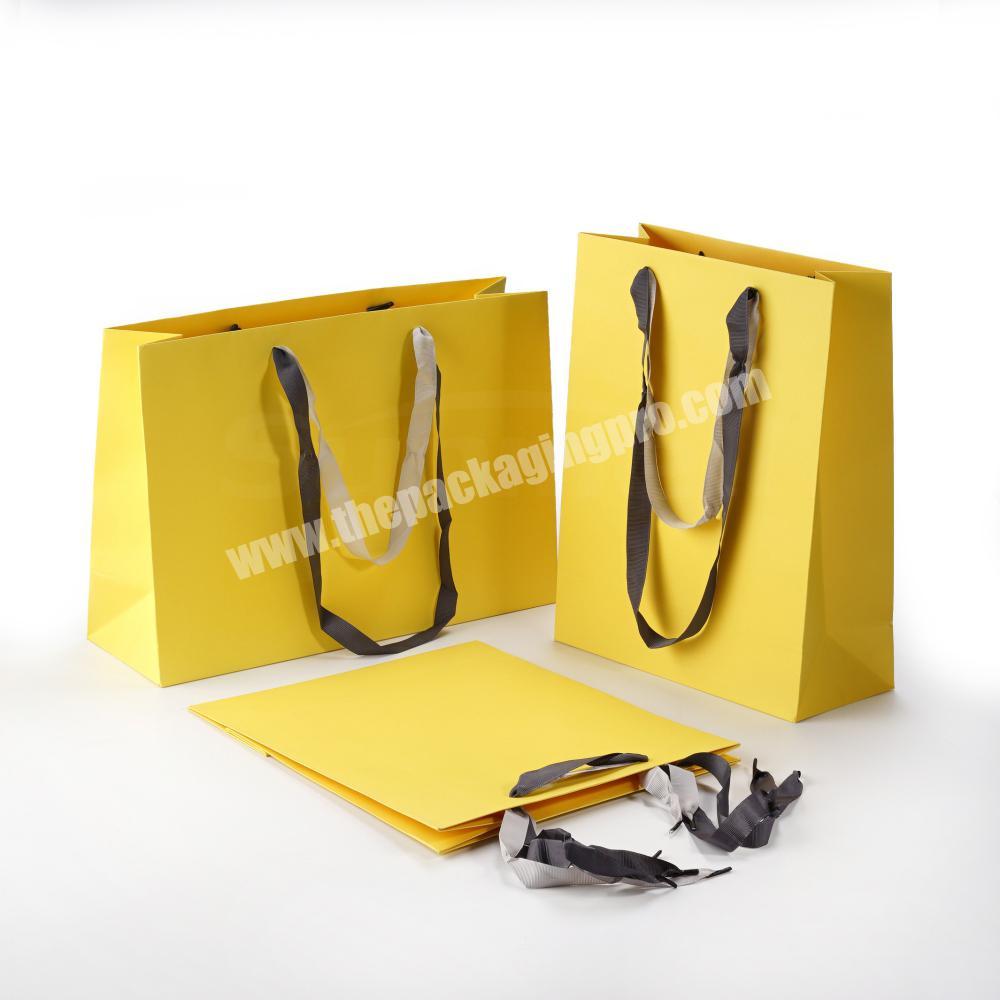 quality solid yellow color recycled paper promotional gift bag with double ribbon drawstring handle