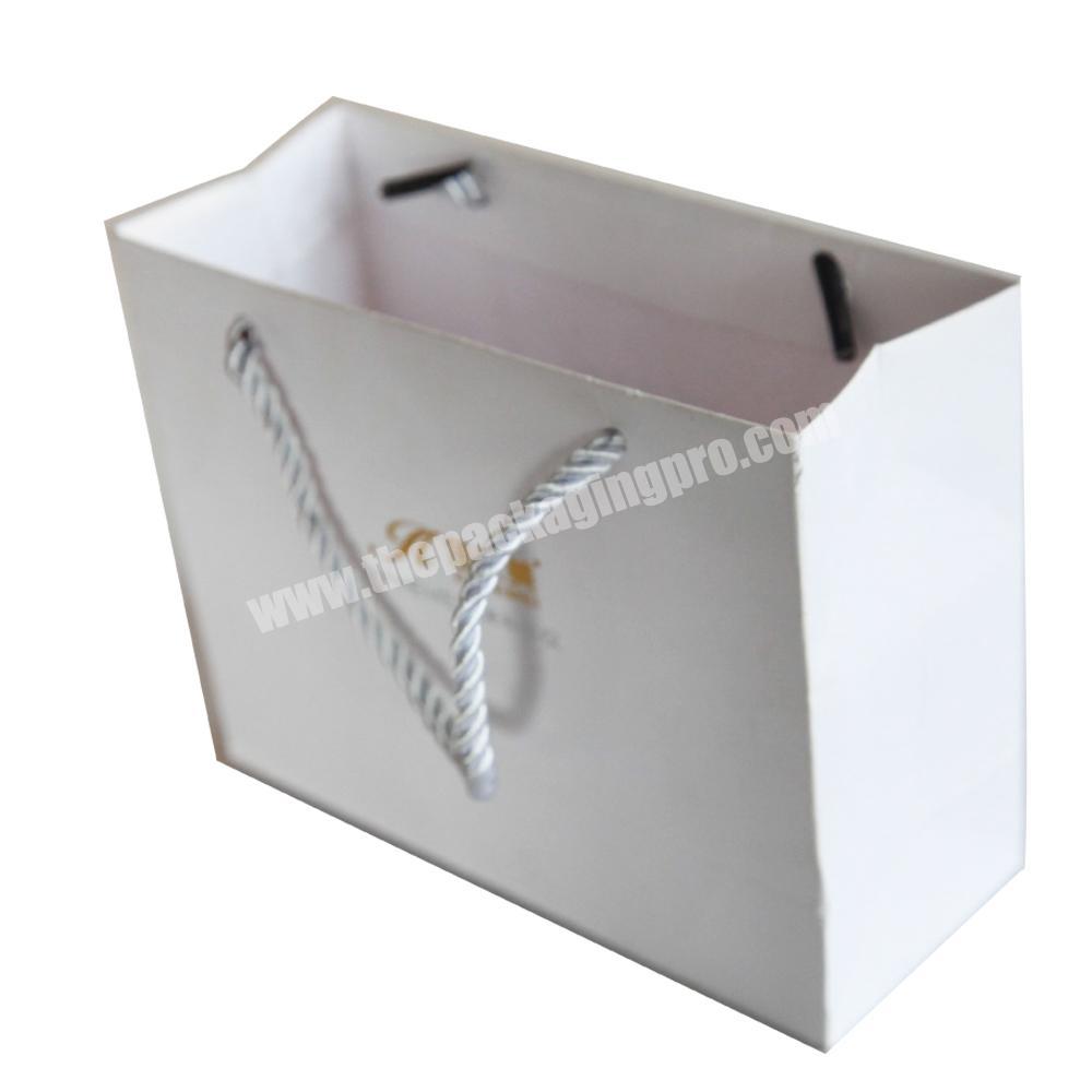 white boutique paper bag with logo print custom hand rope style