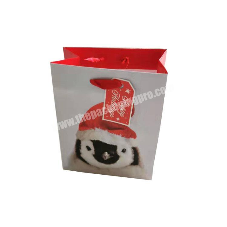 Wholesale kraft mini Christmas gift bag with handle and custom Logo shopping paper bag