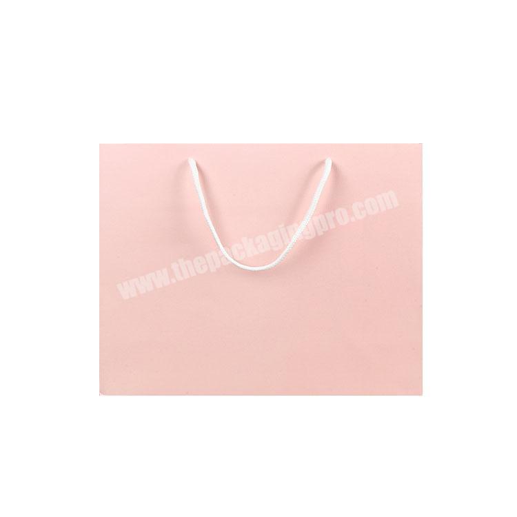Wholesale white card  cute pink famous brand paper bag coated gift packaging garment bag custom logo handle