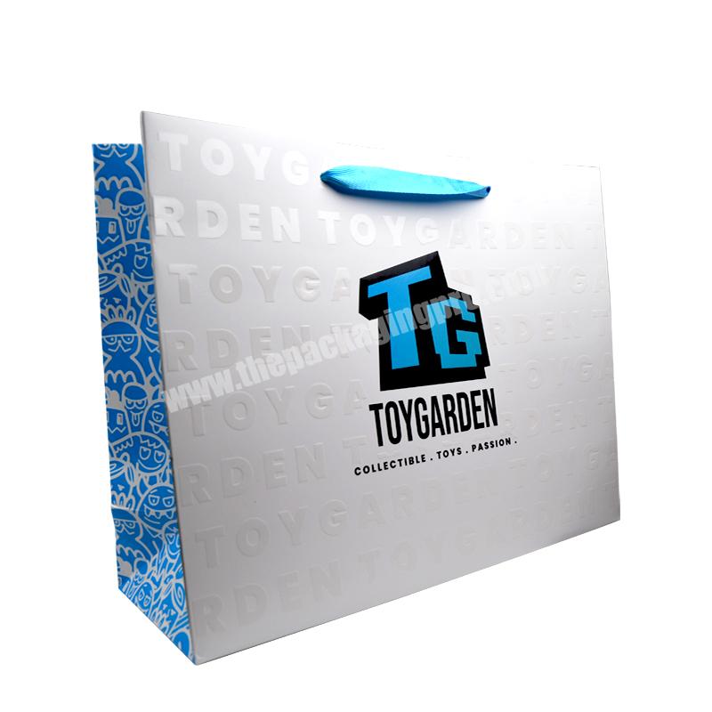 Luxury Customized White and Blue Gift Shopping Paper Bag With UV and Emboss Logo