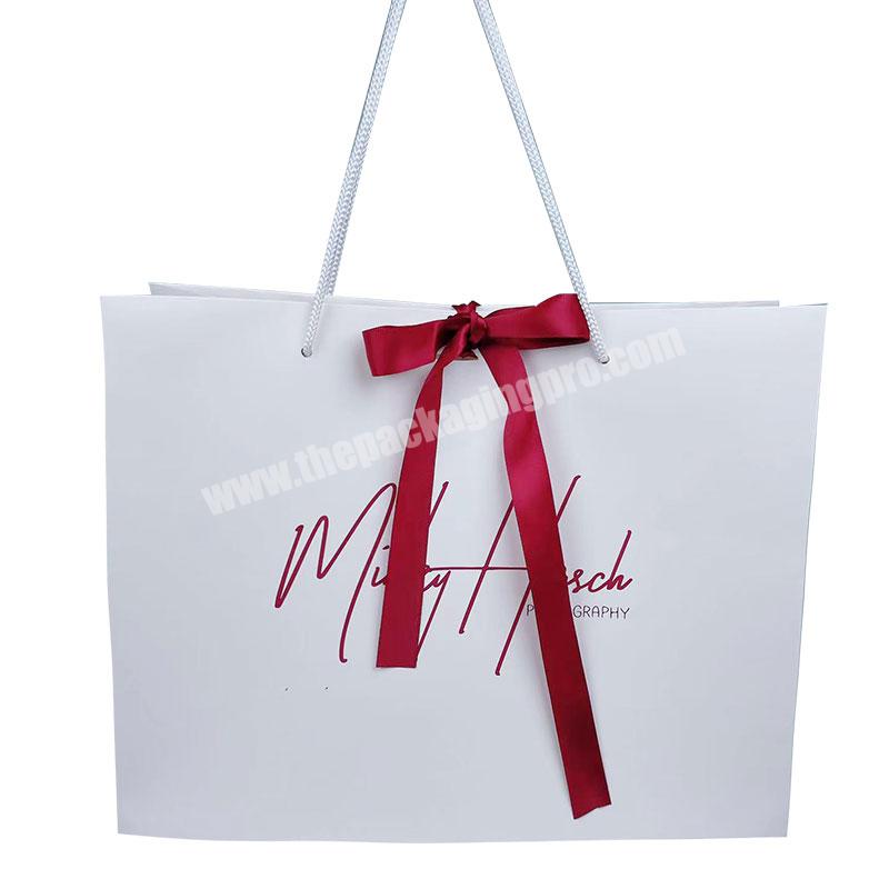 Luxury Free Sample Customized Logo Design CMYK Printing Gift Packaging Art Paper Bag With Red Bowknot