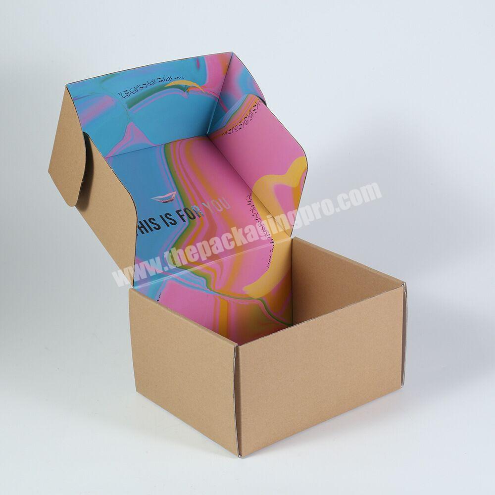 Natural kraft cardboard shipping boxes with pink inside