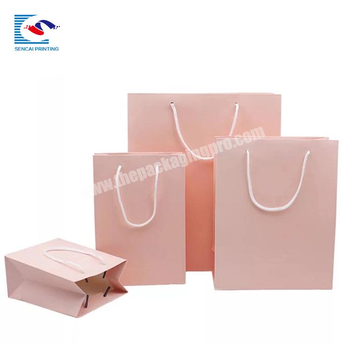 Wholesale custom logo printed simple luxury gift art paper packaging pink bag with handle