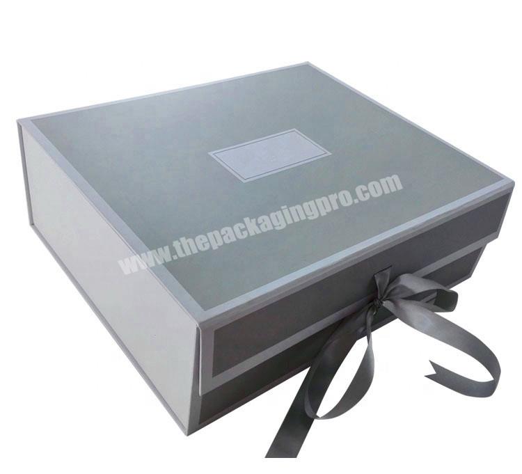 Gray colored gift packaging box with silk ribbon for dress