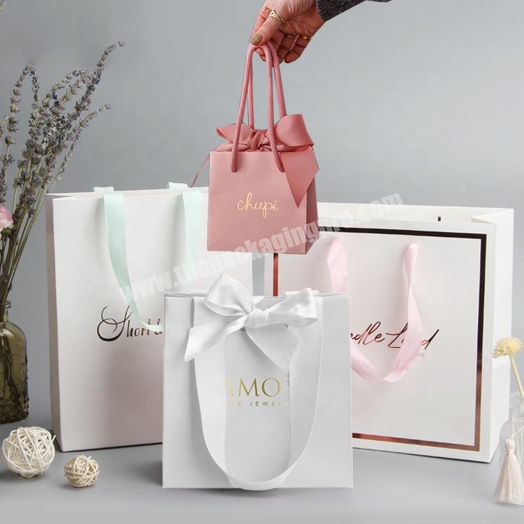 Yiwu Custom Matt Lamination Luxury White Paper Shopping Bag Small Rose Gold Foil Logo Jewelry Gift Bags With Ribbon Bow Tie